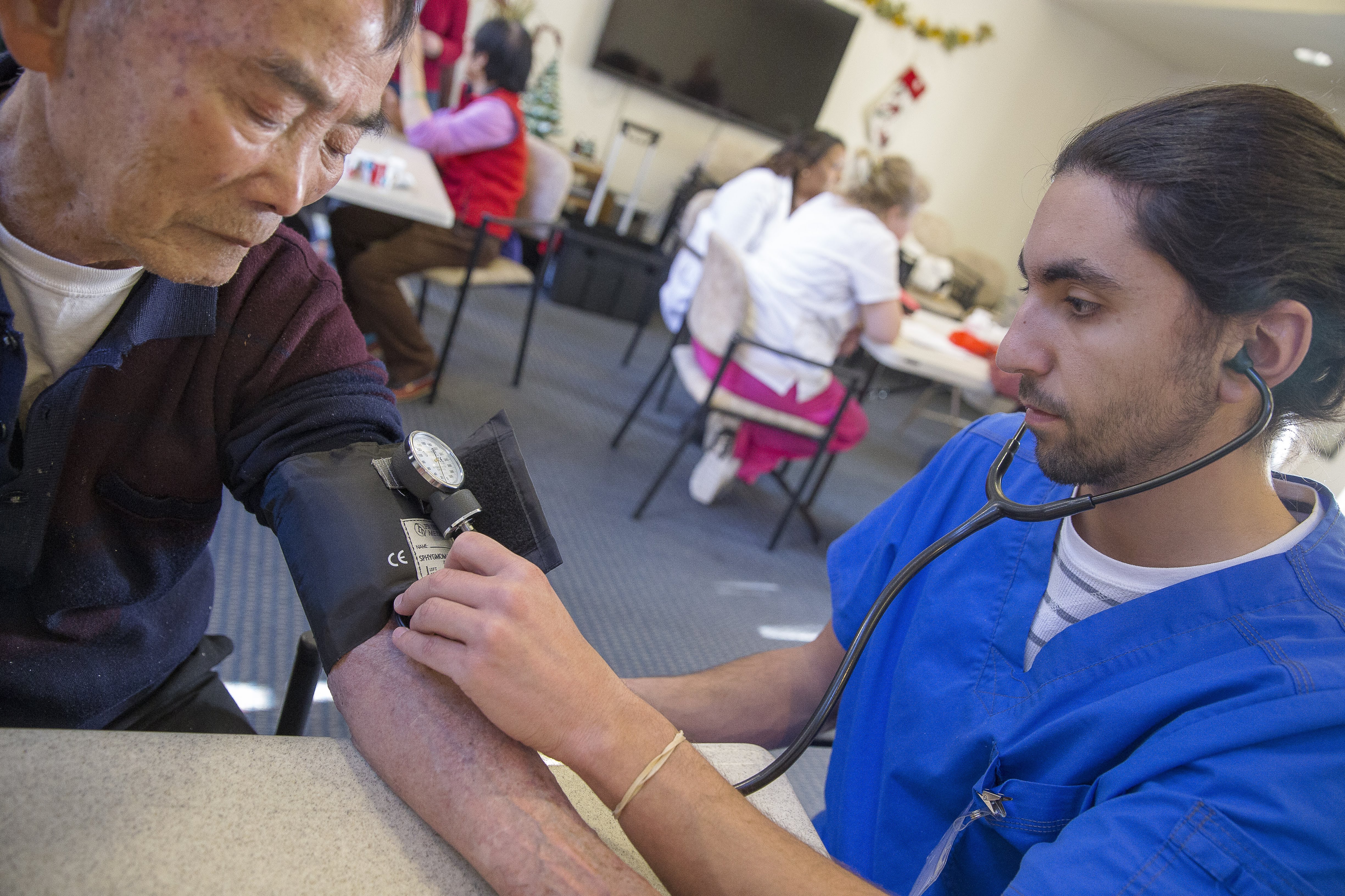 A nursing student checking blood pressure