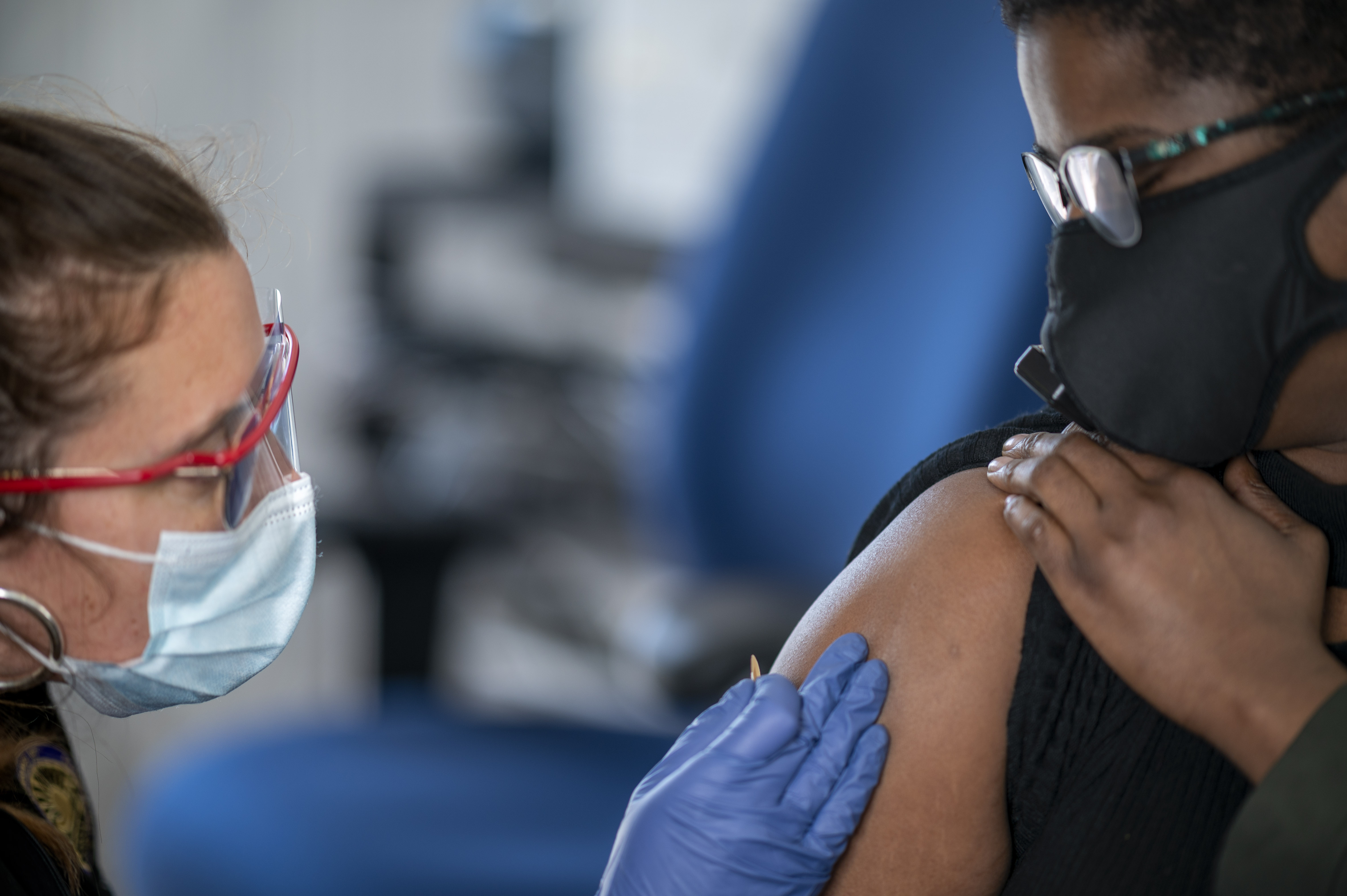 A nursing student administering covid vaccines