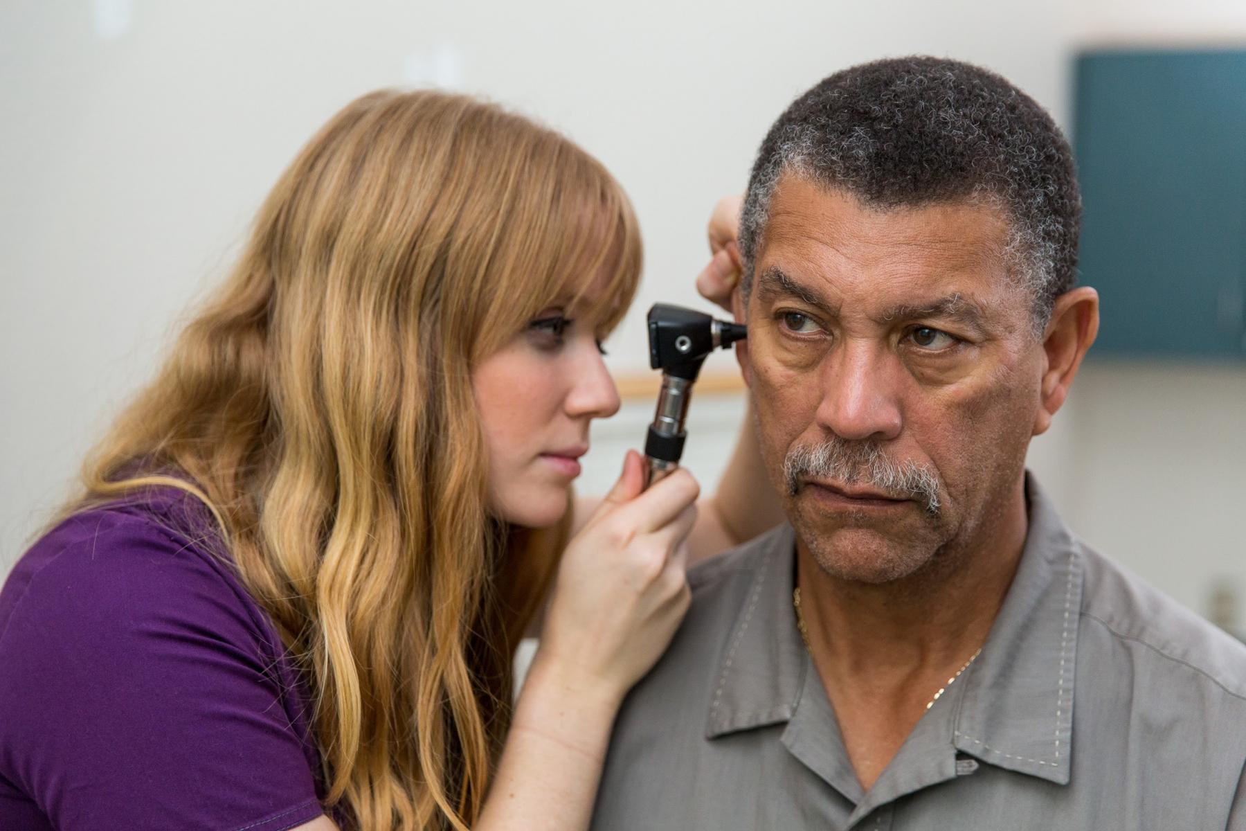 Student checking an ear infection 