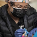 A nursing student administering covid vaccines