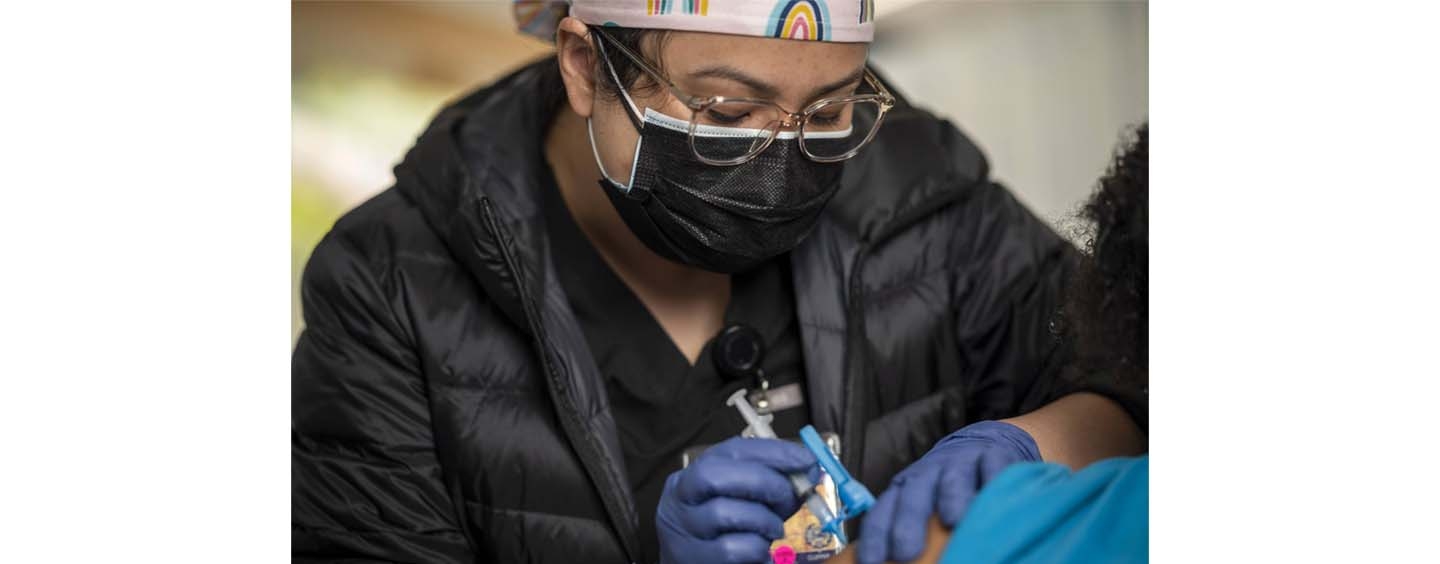 A nursing student administering covid vaccines